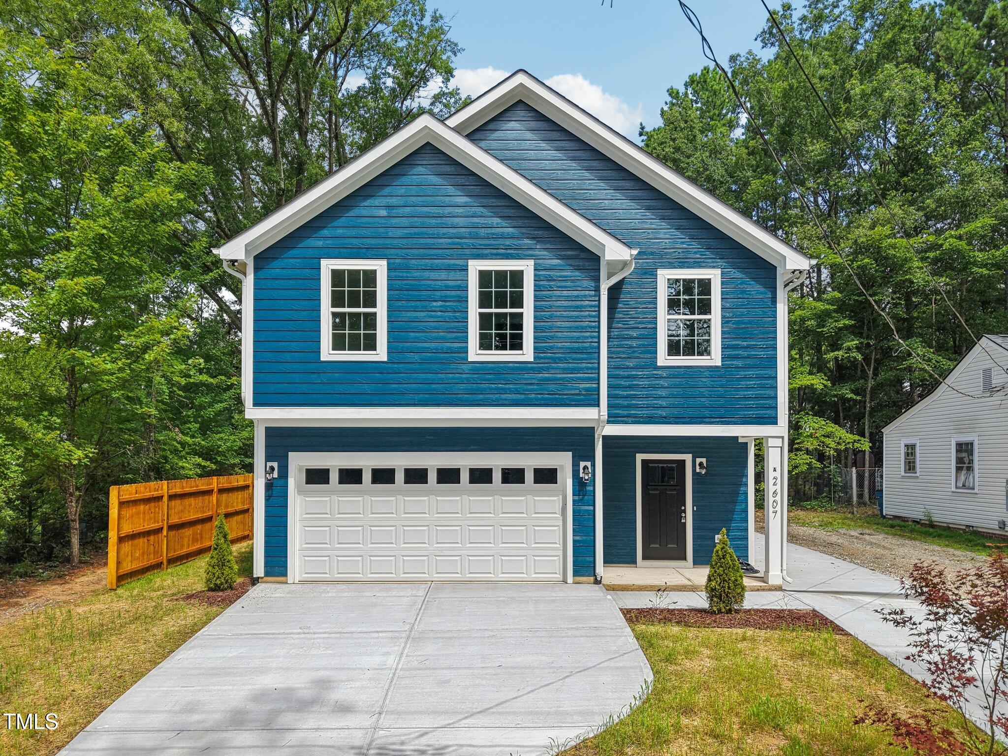 2607 Duke Homestead Road, Unit A Durham, NC 27705 - Photo 21 of 27 a front view of a house with garden