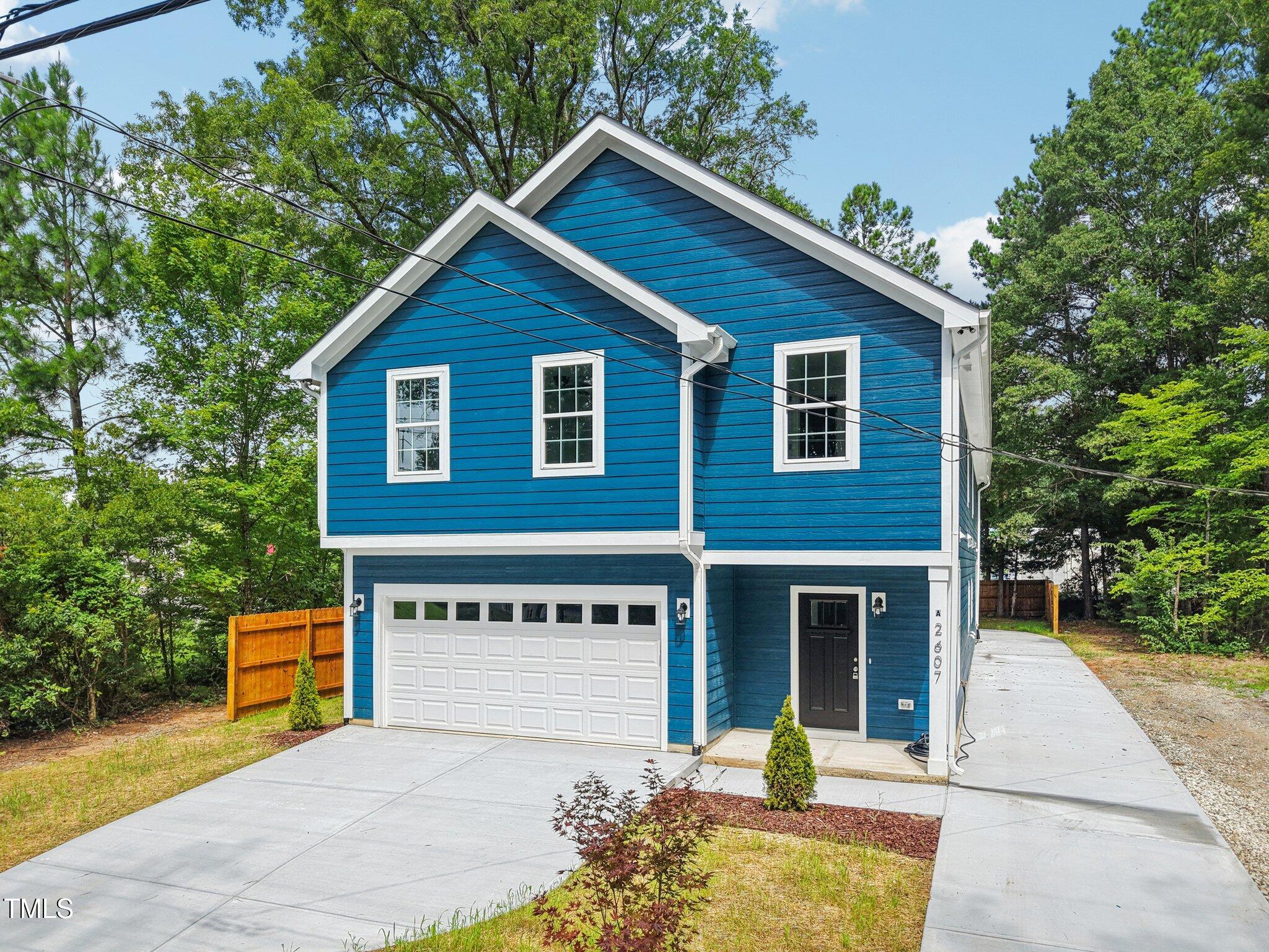 2607 Duke Homestead Road, Unit A Durham, NC 27705 - Photo 23 of 27 a front view of a house with a yard