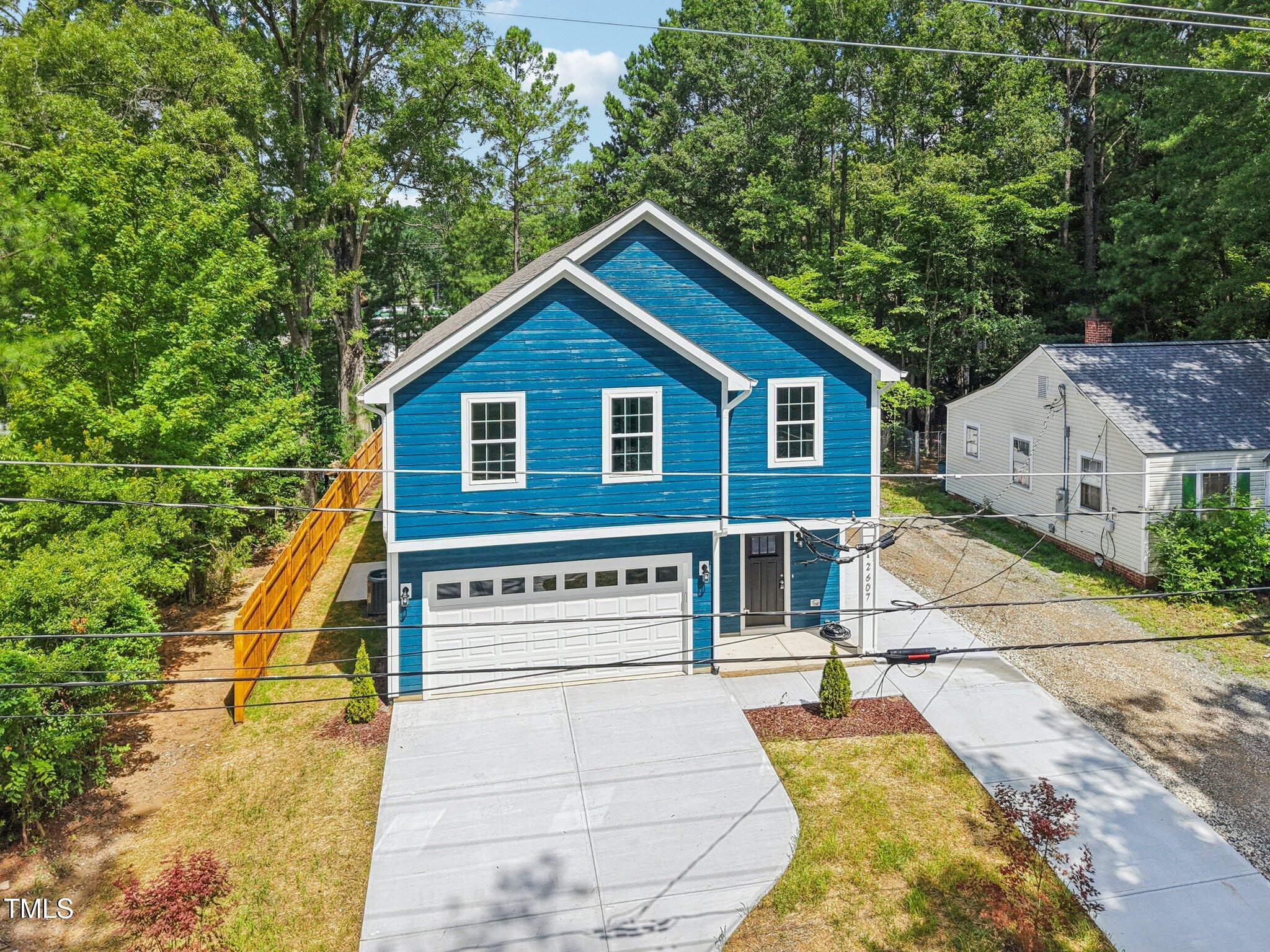 2607 Duke Homestead Road, Unit A Durham, NC 27705 - Photo 26 of 27 a view of a house with a yard and balcony