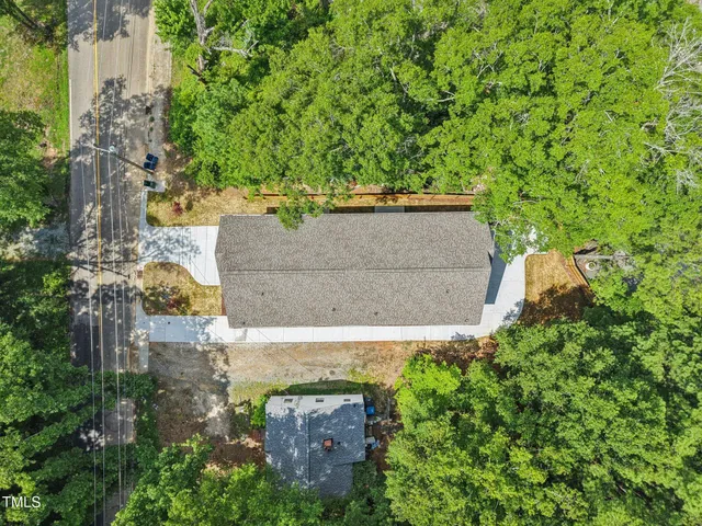 an aerial view of a house with a yard
