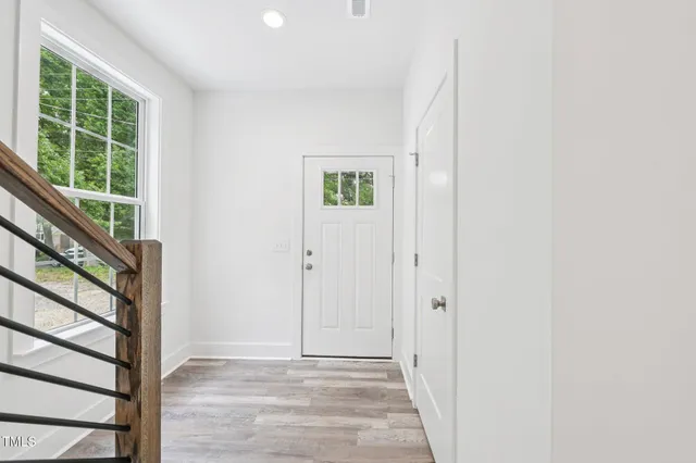 a view of an entryway with wooden floor
