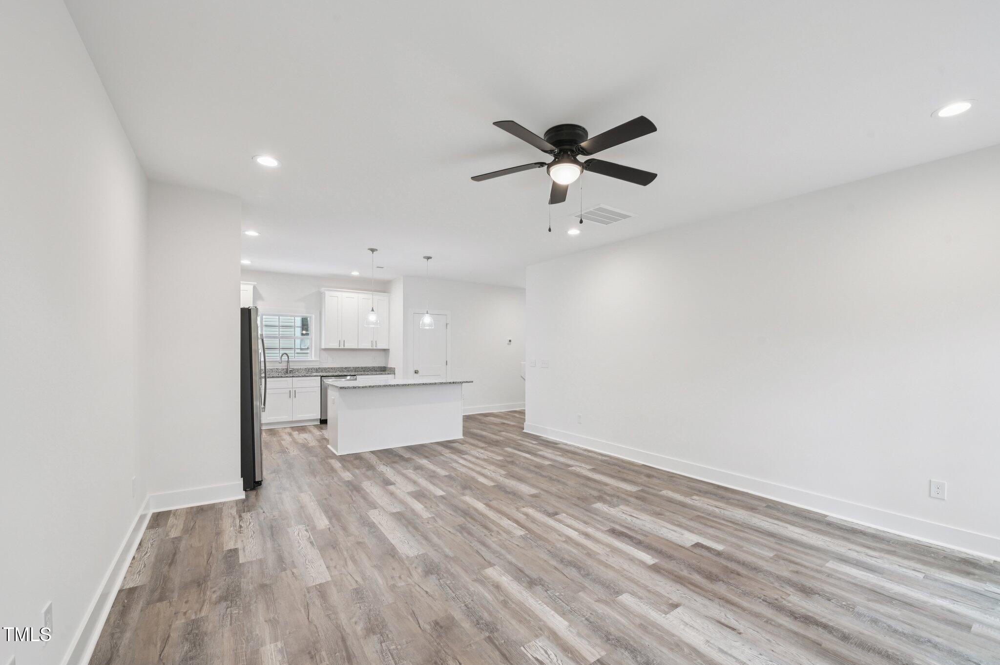 2607 Duke Homestead Road, Unit A Durham, NC 27705 - Photo 7 of 27 a view of a kitchen with wooden floor and a sink
