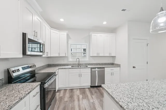 a kitchen with a sink stove and cabinets