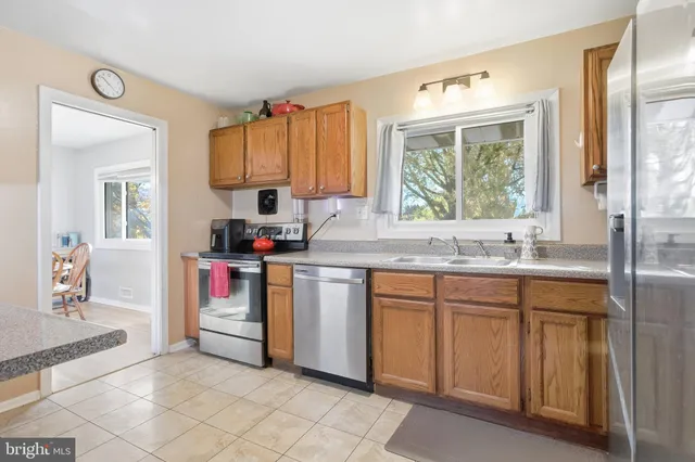 a kitchen with granite countertop a sink and a stove