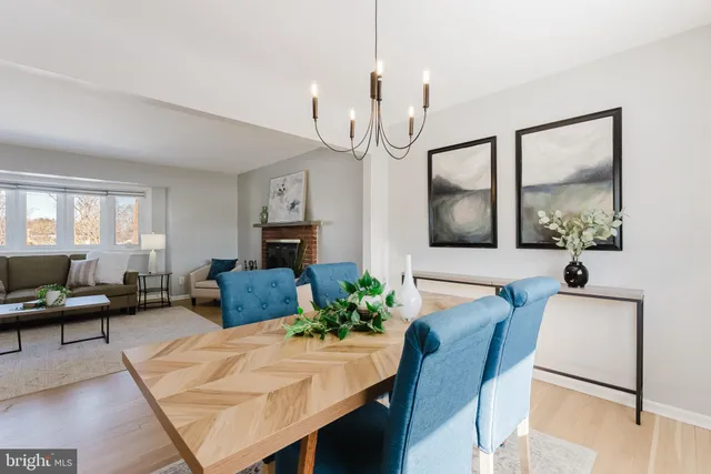 a living room with furniture wooden floor and a chandelier
