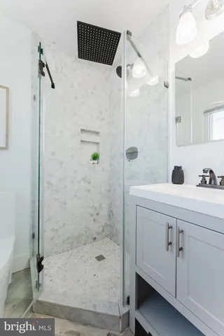 a bathroom with a shower and a sink