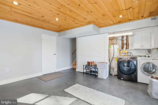 a utility room with sink dryer and washer