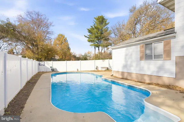 a view of a swimming pool with an outdoor seating