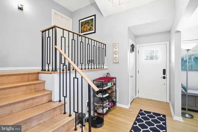 a view of entryway with wooden floor and windows