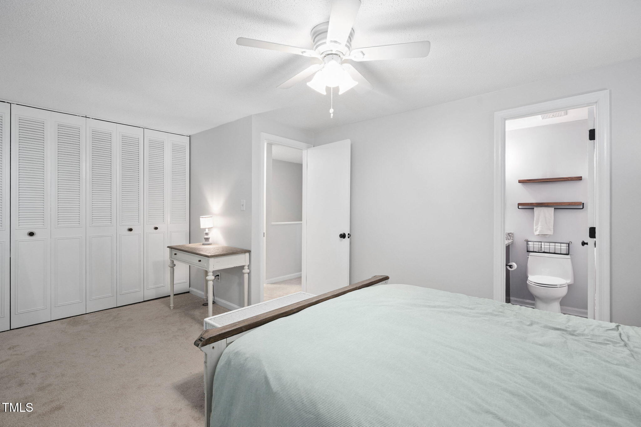 7286 Shellburne Drive Raleigh, NC 27612 - Photo 13 of 36 a bedroom with a bed and a chandelier