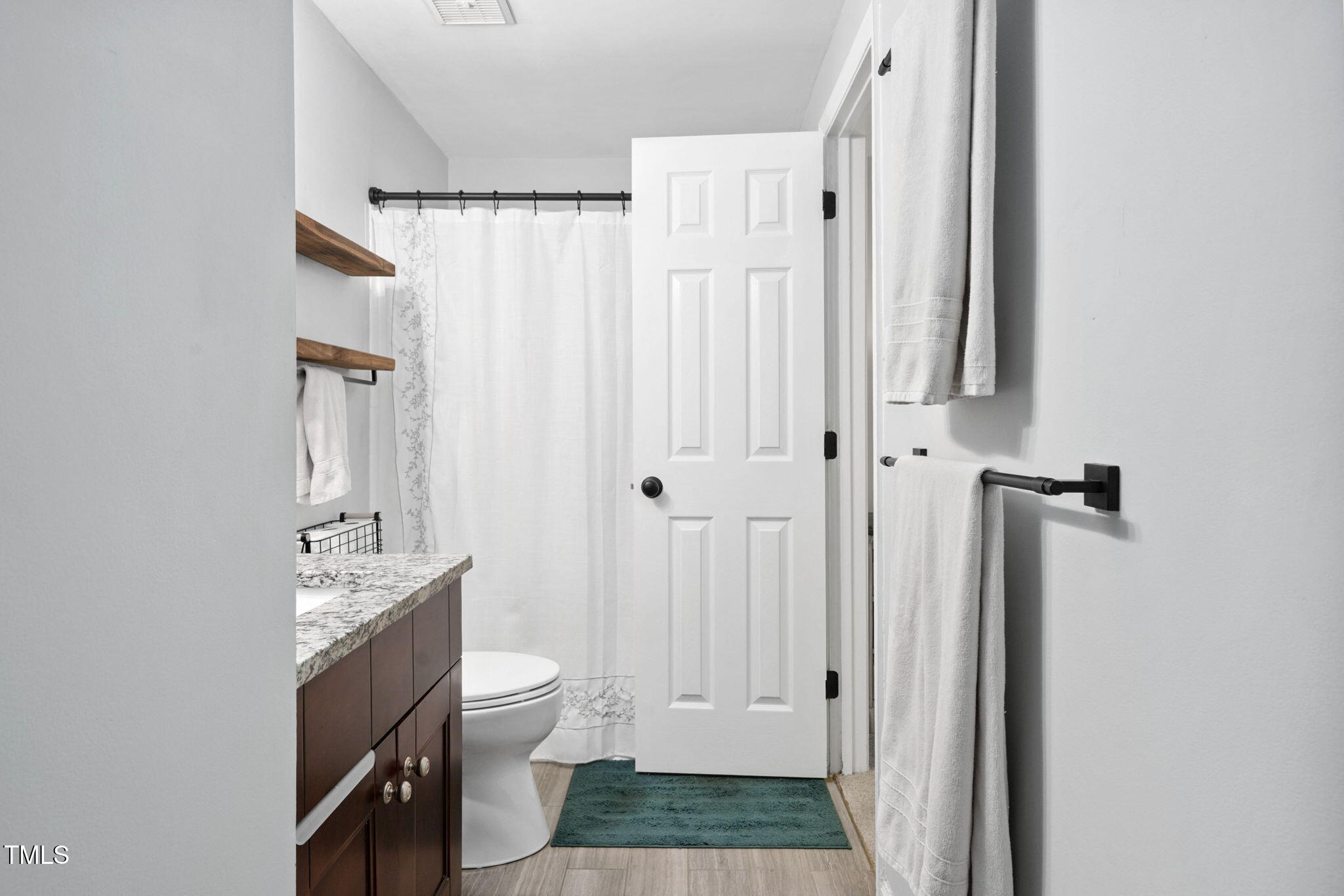 7286 Shellburne Drive Raleigh, NC 27612 - Photo 15 of 36 a bathroom with a sink a toilet and shower