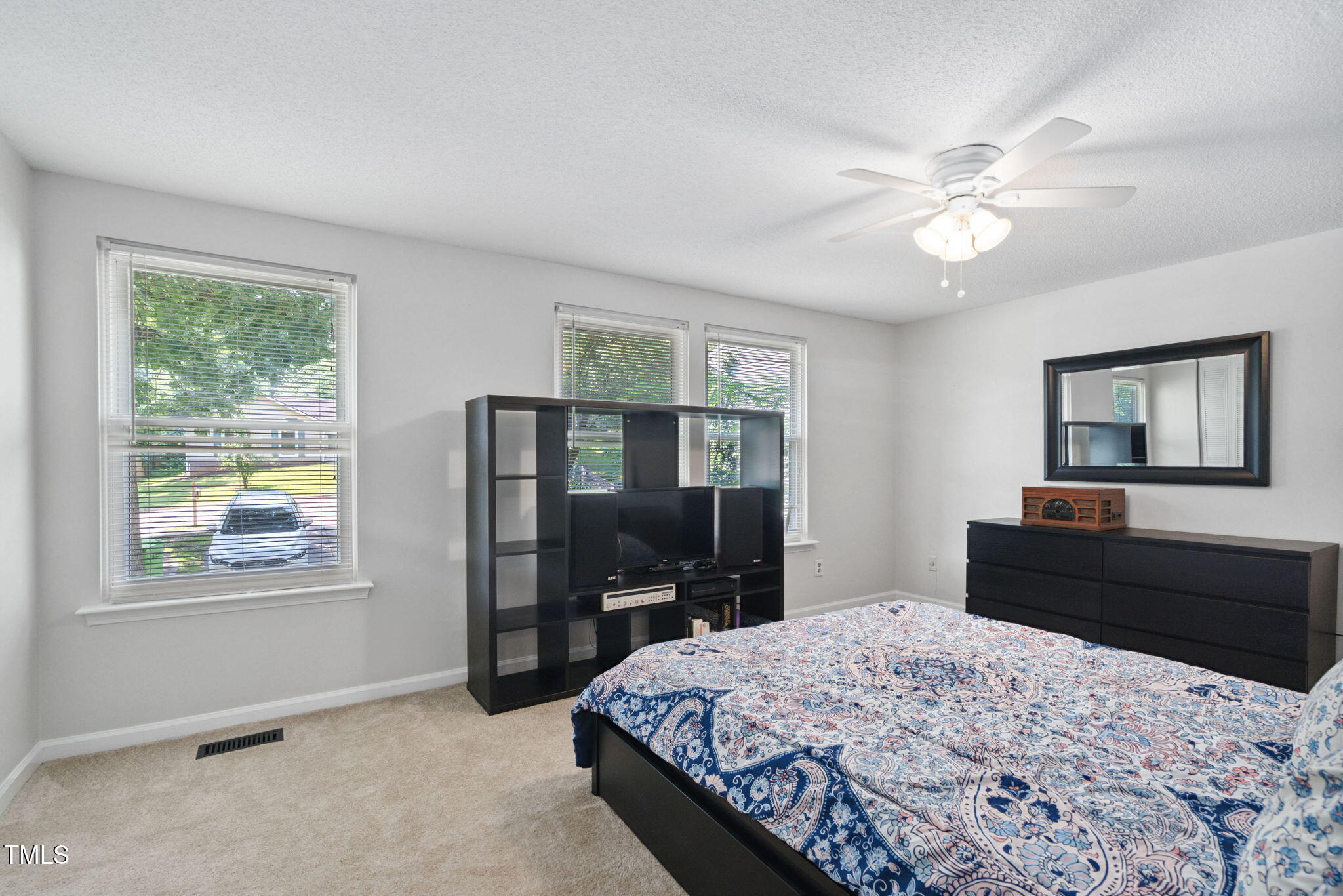 7286 Shellburne Drive Raleigh, NC 27612 - Photo 16 of 36 a bedroom with a bed and a dresser