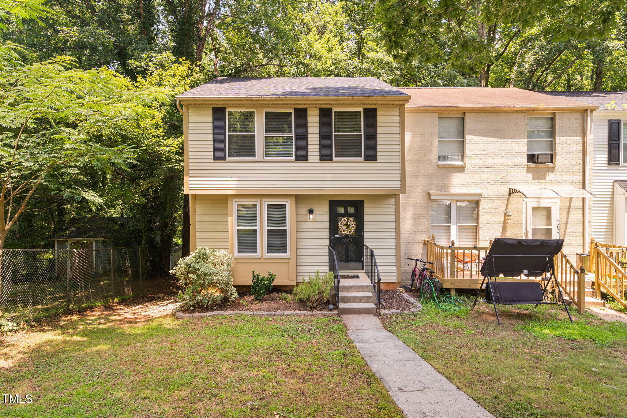 7286 Shellburne Drive Raleigh, NC 27612 - Photo 24 of 36 a front view of a house with garden