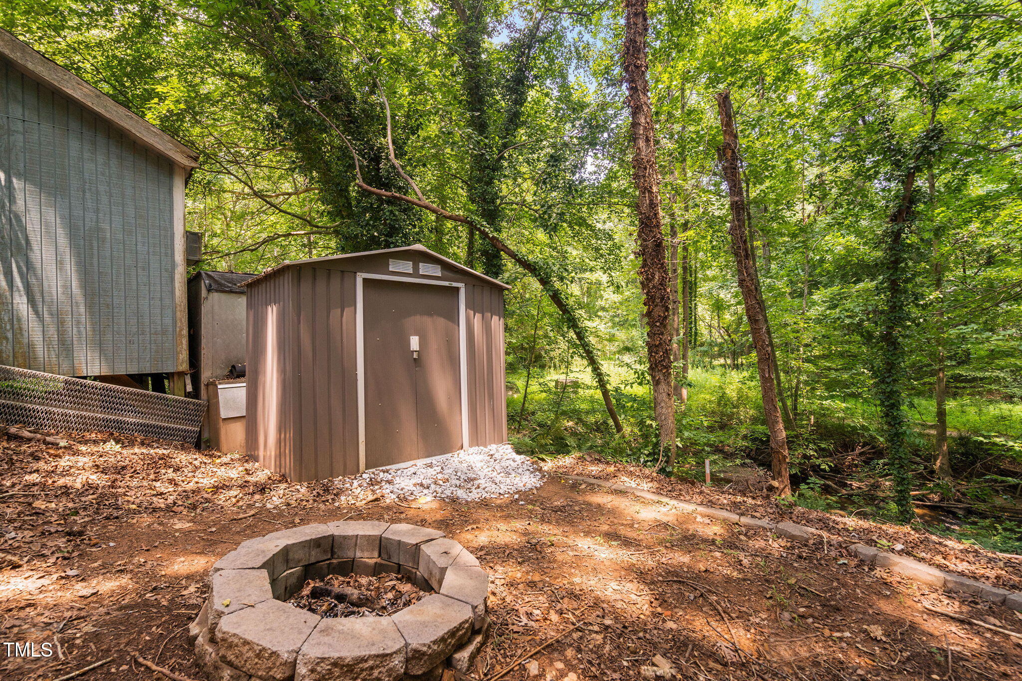 7286 Shellburne Drive Raleigh, NC 27612 - Photo 31 of 36 a backyard of a house with a large tree