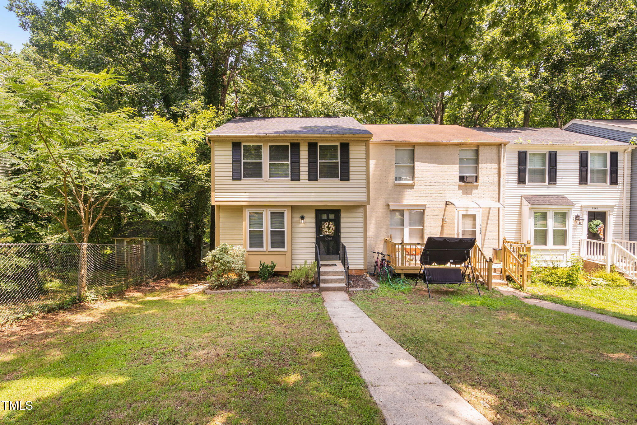 7286 Shellburne Drive Raleigh, NC 27612 - Photo 34 of 36 a front view of a house with a yard table and chairs