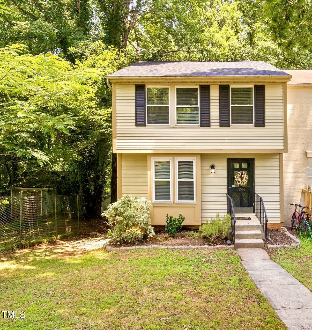 7286 Shellburne Drive Raleigh, NC 27612 - Photo 35 of 36 a front view of a house with garden