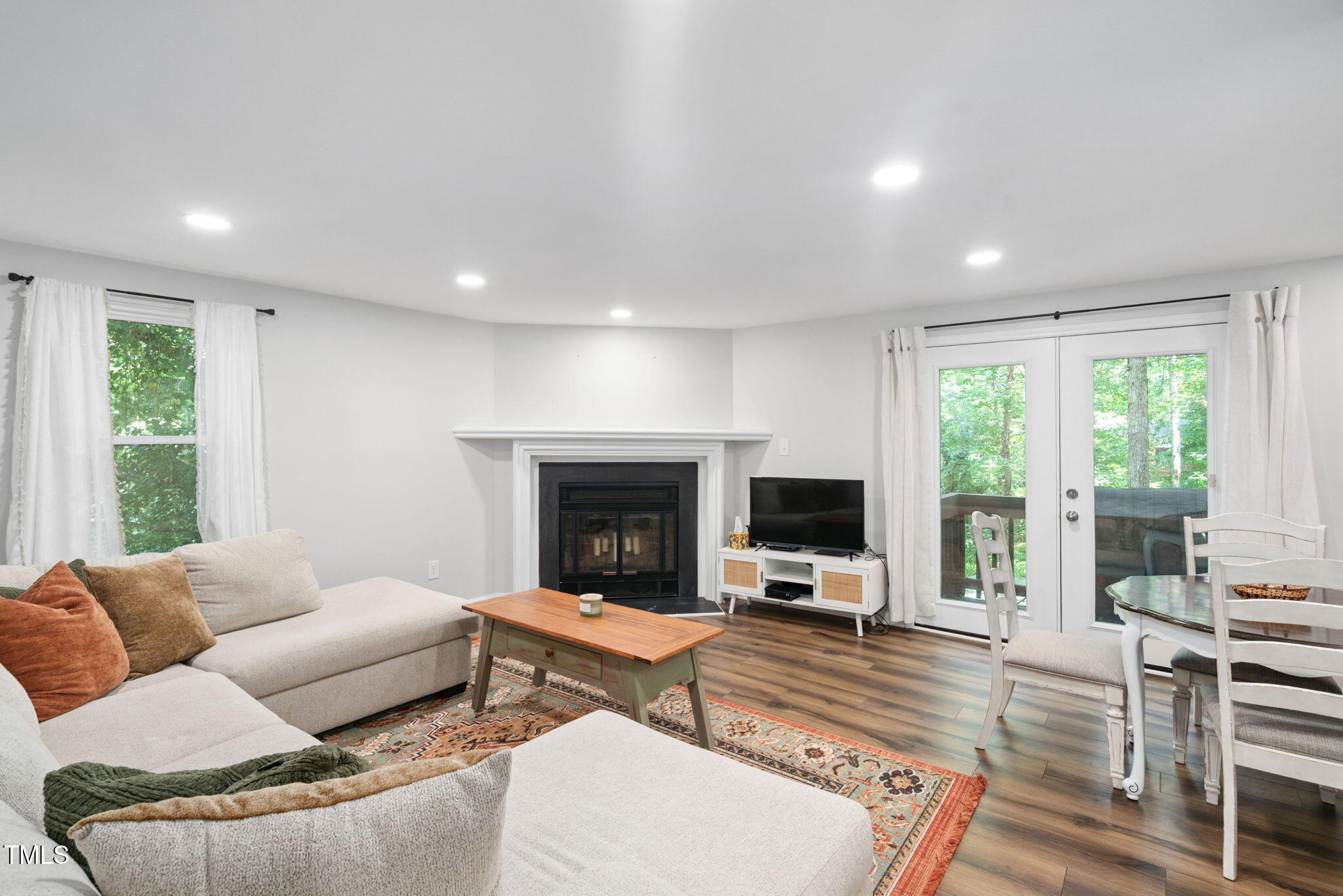 7286 Shellburne Drive Raleigh, NC 27612 - Photo 5 of 36 a living room with furniture flat screen tv and a fireplace