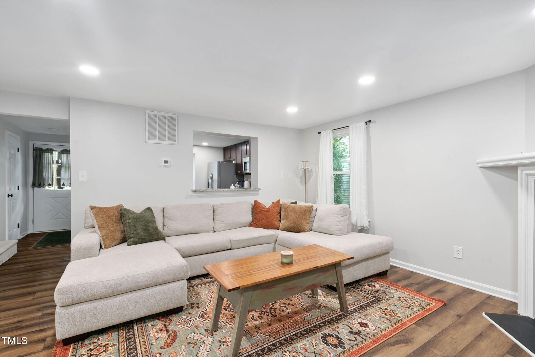 7286 Shellburne Drive Raleigh, NC 27612 - Photo 8 of 36 a living room with furniture and a rug