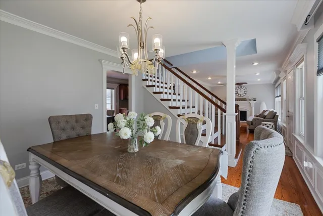 a view of a dining room with furniture and a chandelier