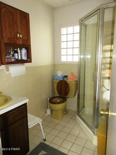 208 Rodeo Drive Hawley, PA 18428 - Photo 10 of 15 a bathroom with a toilet and a shower