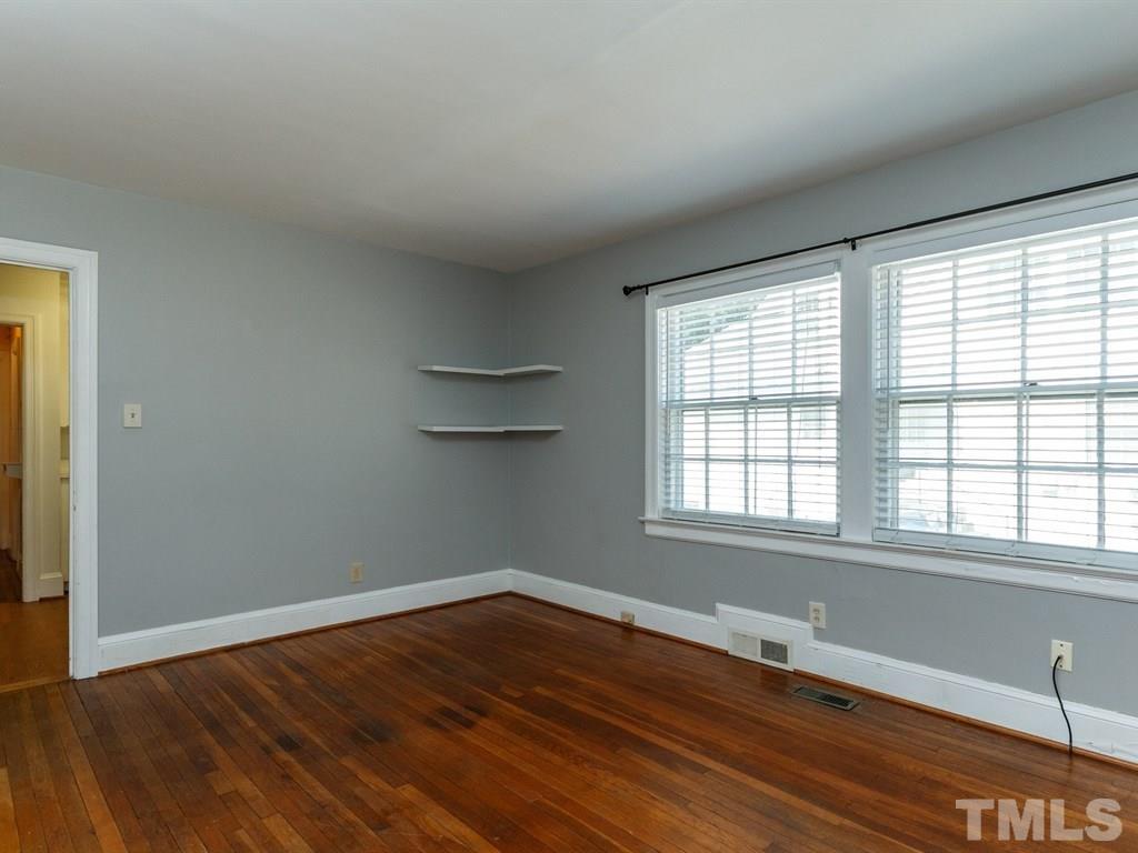 2715 Kilgore Avenue Raleigh, NC 27607 - Photo 2 of 25 a view of an empty room with wooden floor and a window