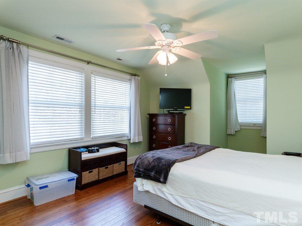 2715 Kilgore Avenue Raleigh, NC 27607 - Photo 11 of 25 a bedroom with a bed and a chandelier