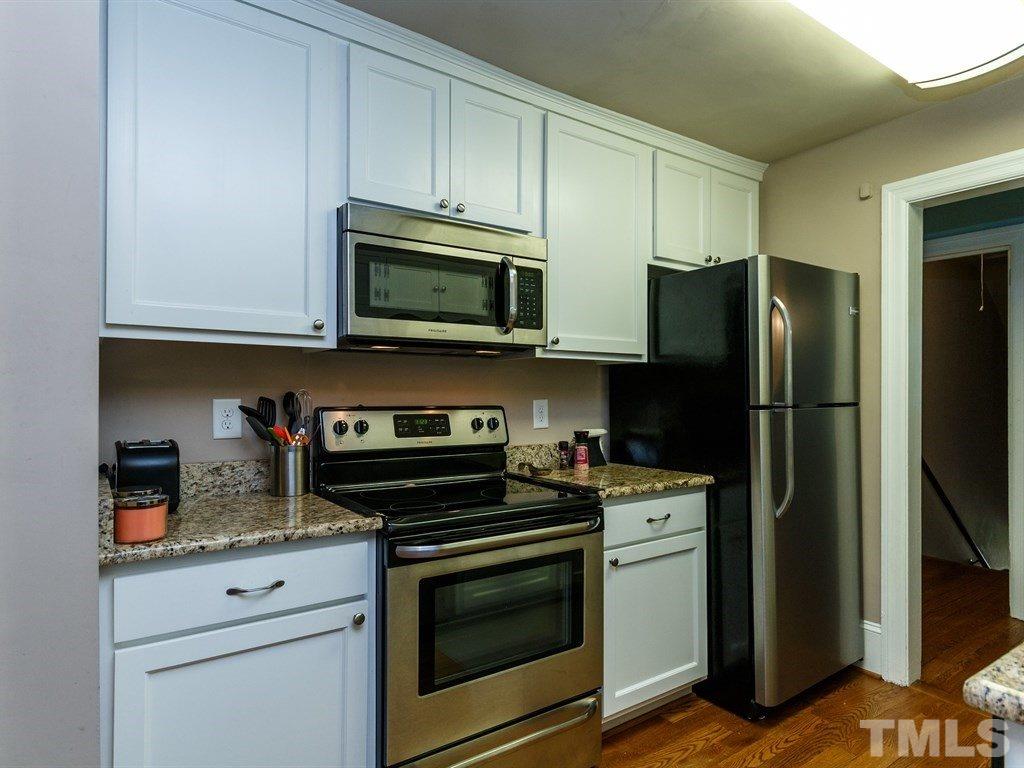 2715 Kilgore Avenue Raleigh, NC 27607 - Photo 15 of 25 a kitchen with stainless steel appliances granite countertop a refrigerator stove and microwave