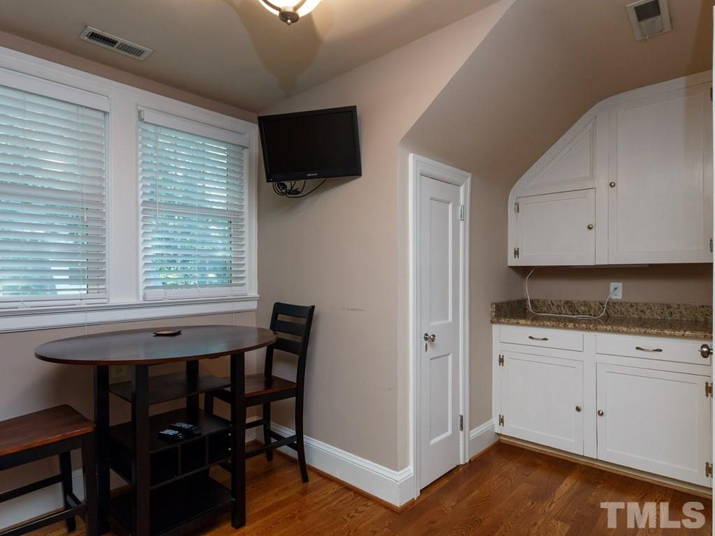 2715 Kilgore Avenue Raleigh, NC 27607 - Photo 17 of 25 a kitchen with a table chairs refrigerator and microwave