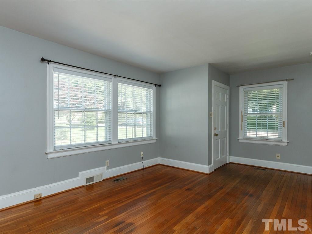 2715 Kilgore Avenue Raleigh, NC 27607 - Photo 3 of 25 a view of an empty room with wooden floor and a window