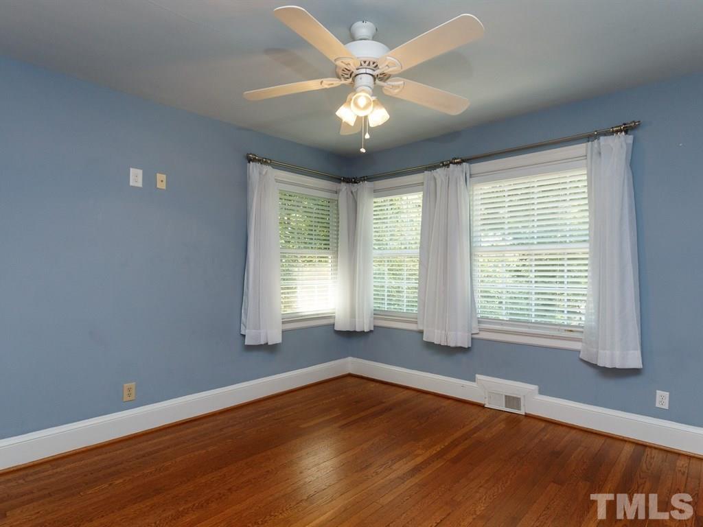 2715 Kilgore Avenue Raleigh, NC 27607 - Photo 22 of 25 a view of an empty room with wooden floor and a window