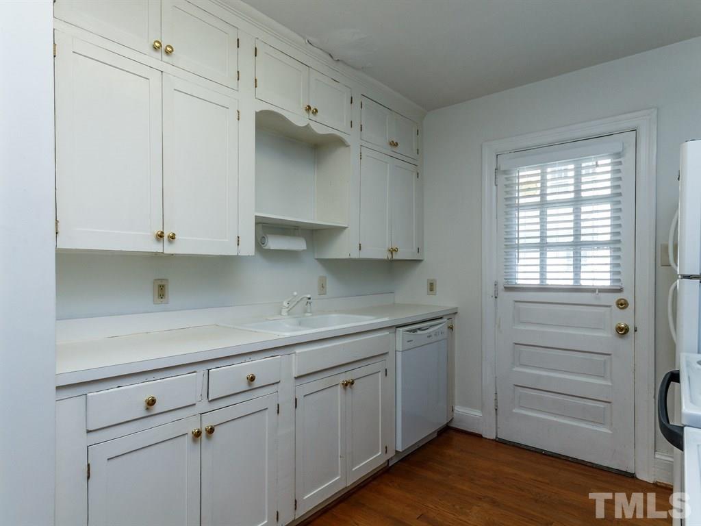 2715 Kilgore Avenue Raleigh, NC 27607 - Photo 4 of 25 a kitchen with white cabinets and a window