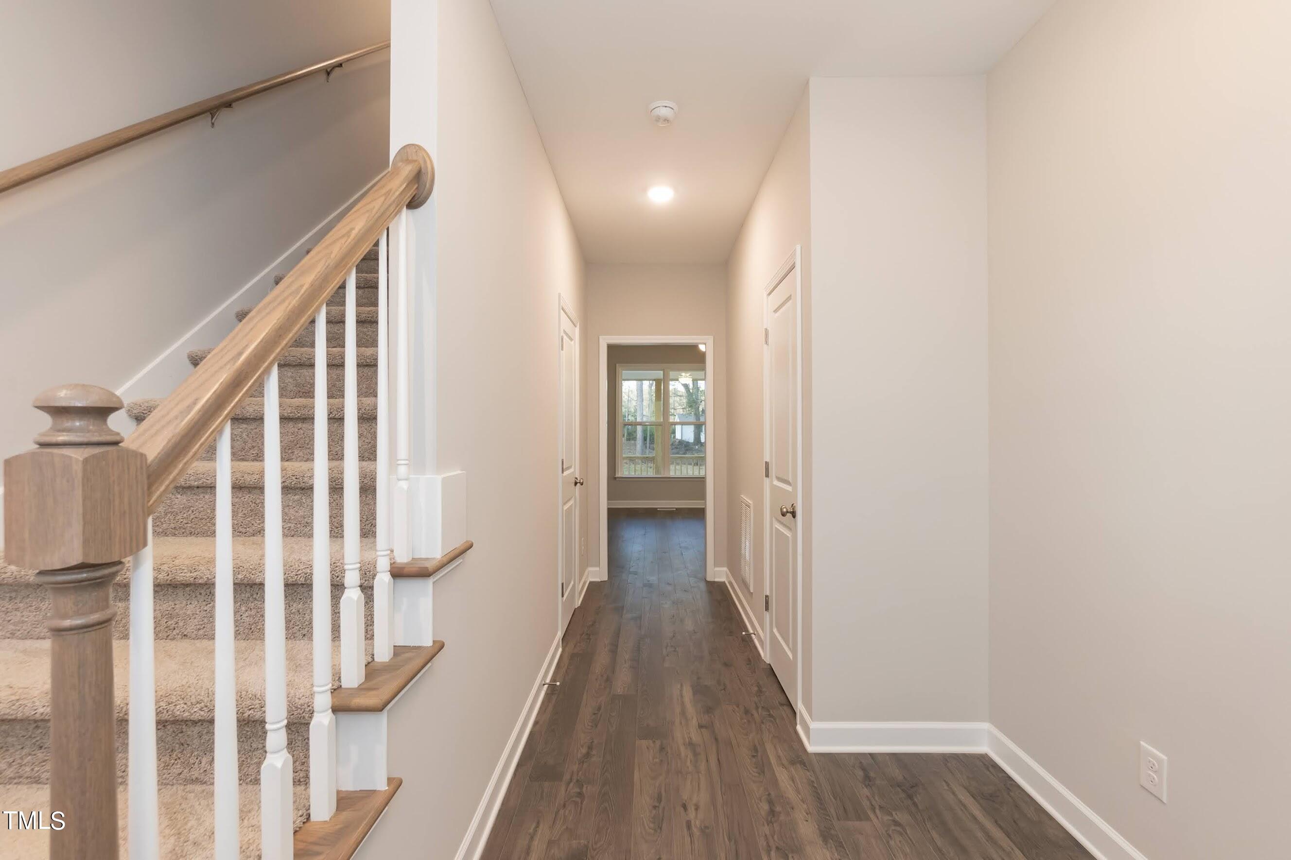 500 Poplar Springs Church Road Raleigh, NC 27603 - Photo 11 of 36 a view of a hallway with wooden floor and staircase