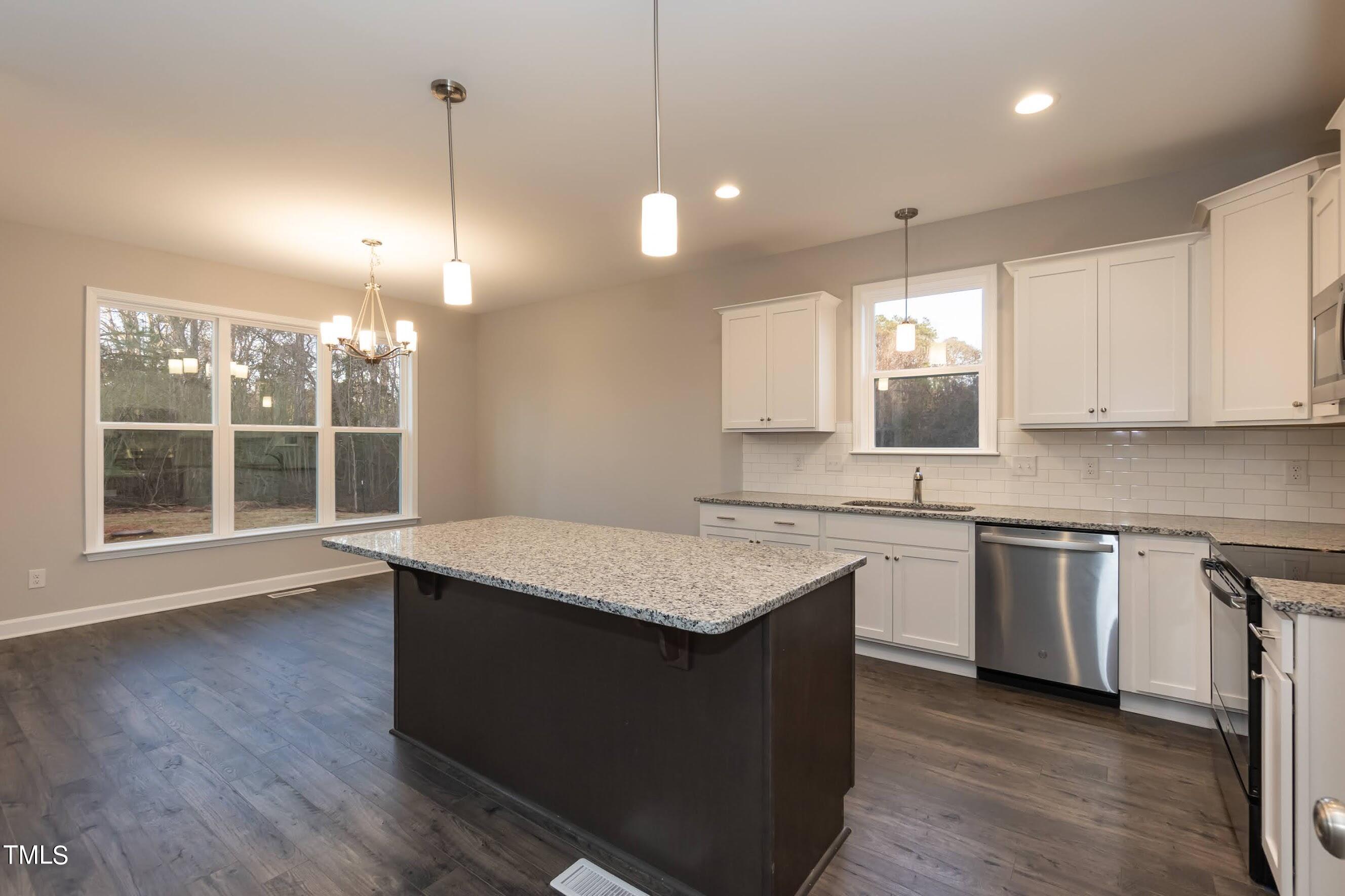 500 Poplar Springs Church Road Raleigh, NC 27603 - Photo 17 of 36 a kitchen with stainless steel appliances granite countertop wooden cabinets a window and a sink