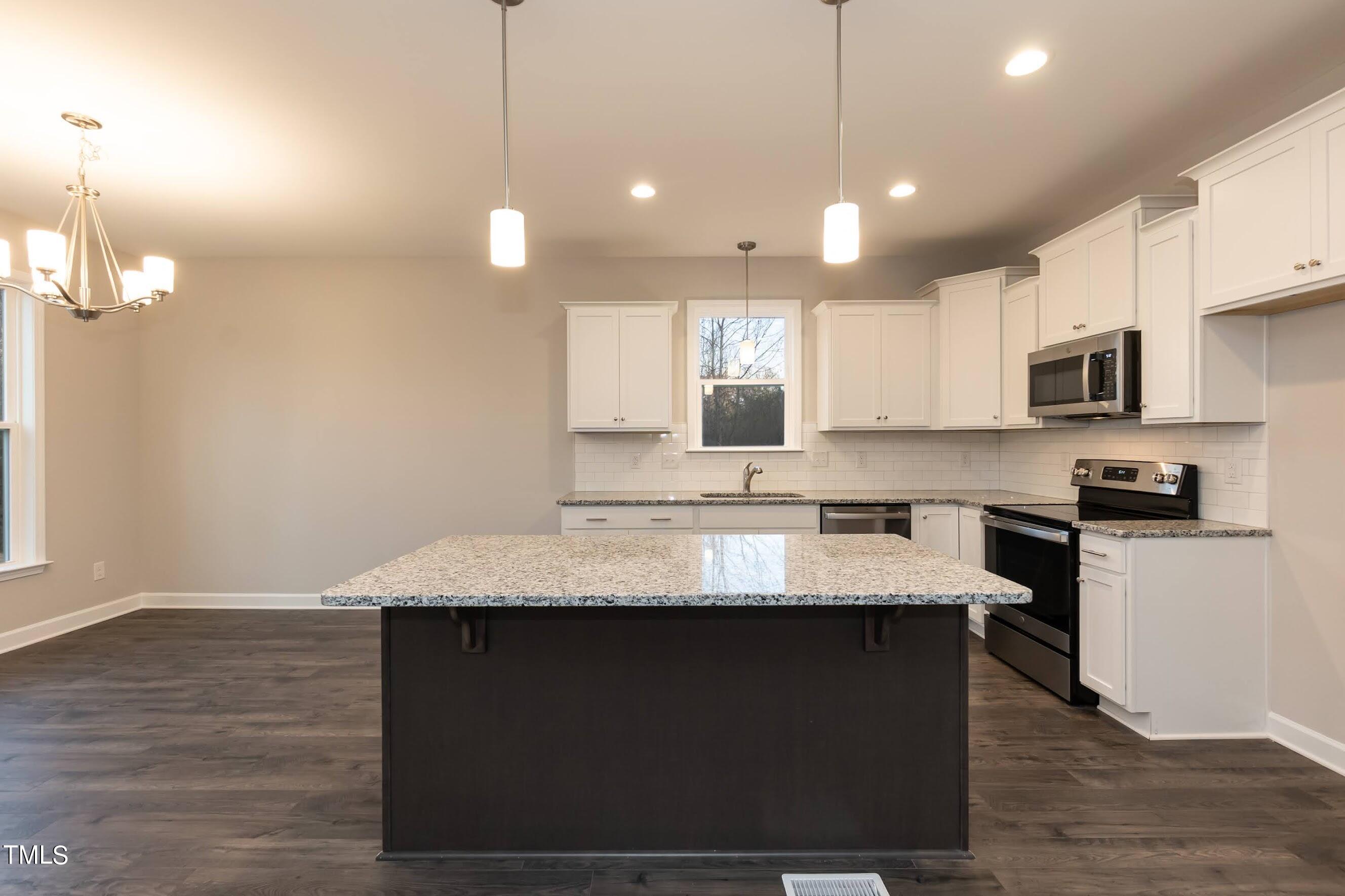 500 Poplar Springs Church Road Raleigh, NC 27603 - Photo 19 of 36 a large kitchen with kitchen island a stove a sink a refrigerator and a microwave