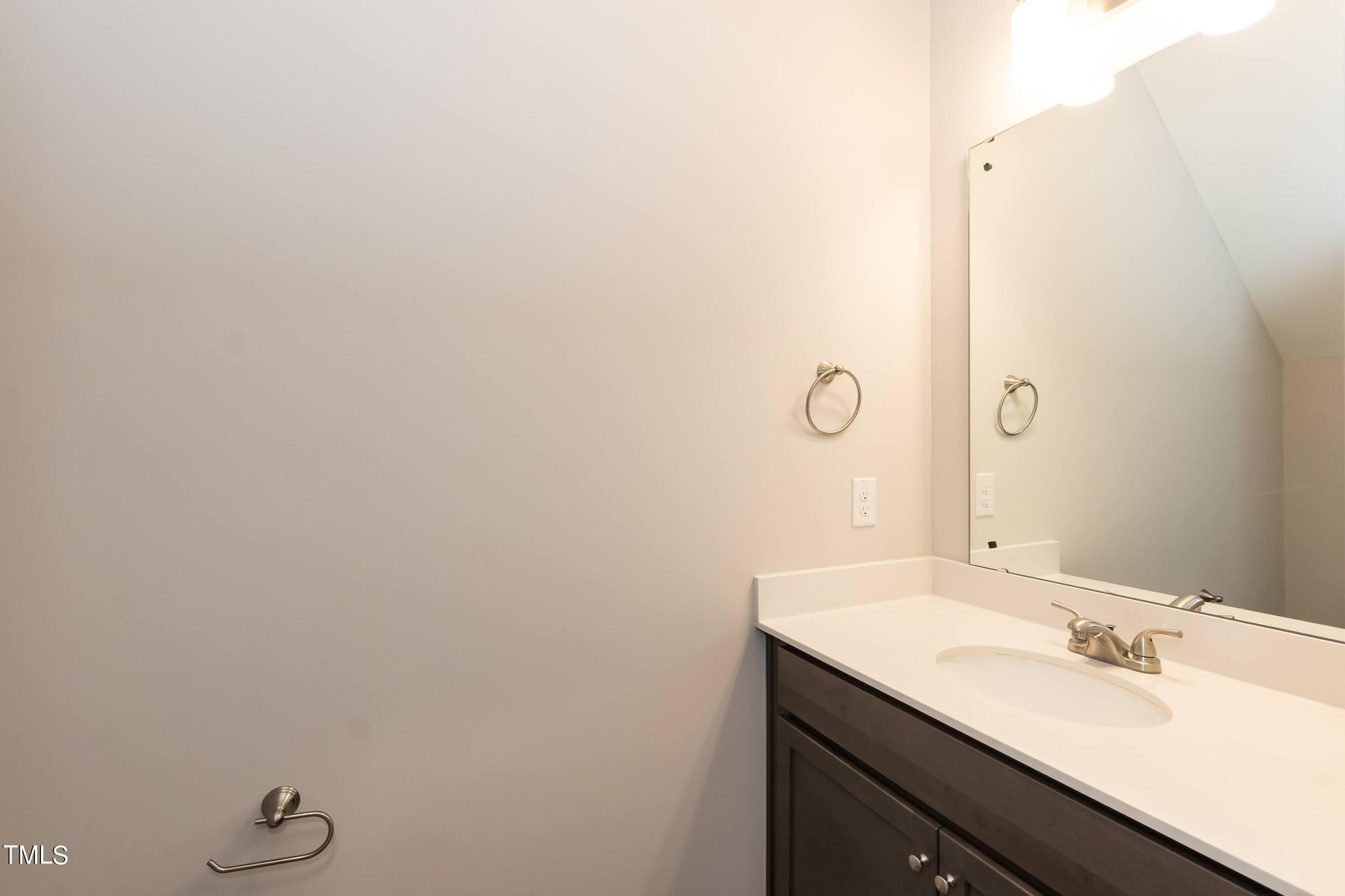 500 Poplar Springs Church Road Raleigh, NC 27603 - Photo 22 of 36 a bathroom with a double vanity sink and mirror