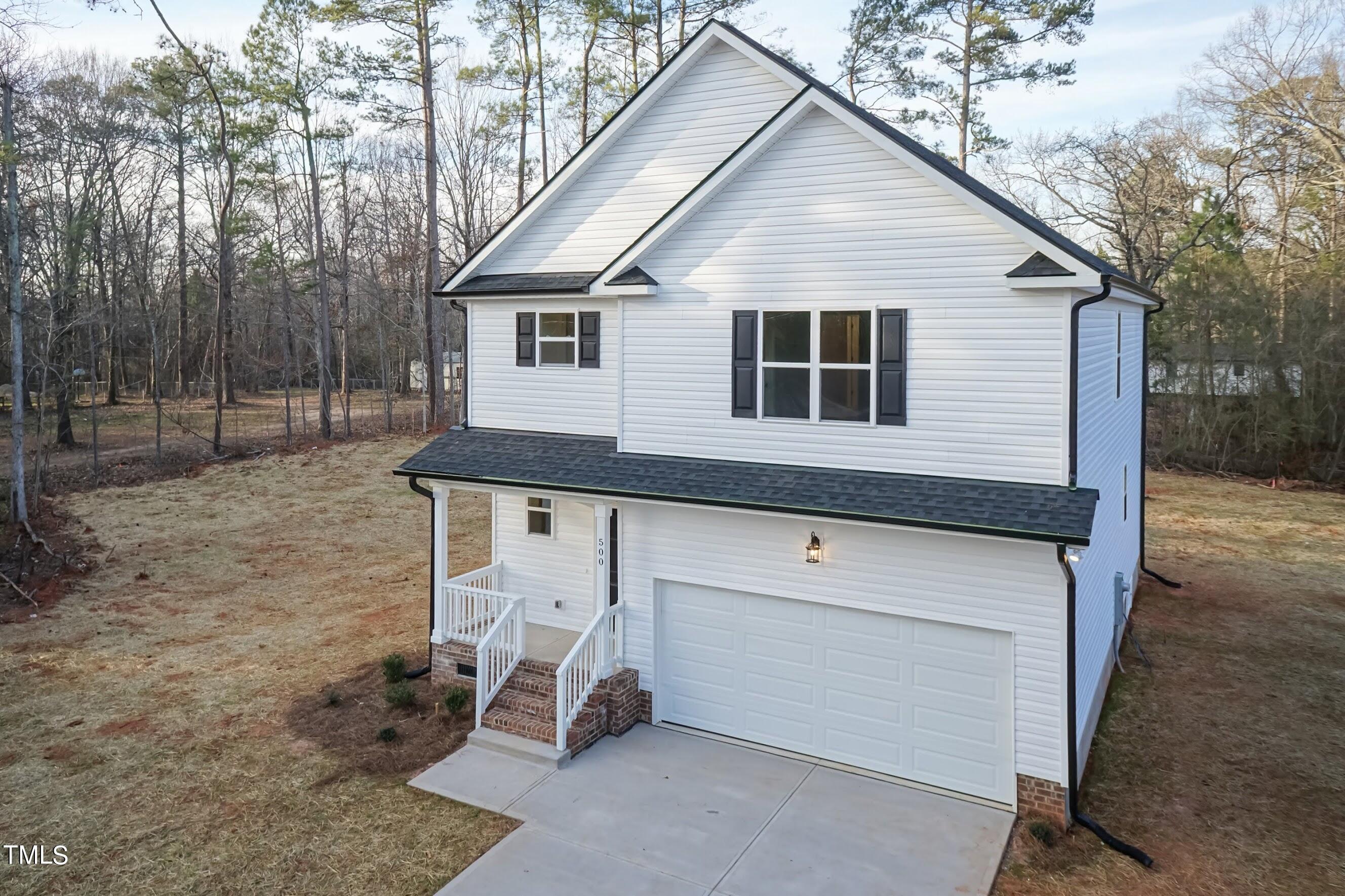 500 Poplar Springs Church Road Raleigh, NC 27603 - Photo 3 of 36 a view of a house with a yard and seating area