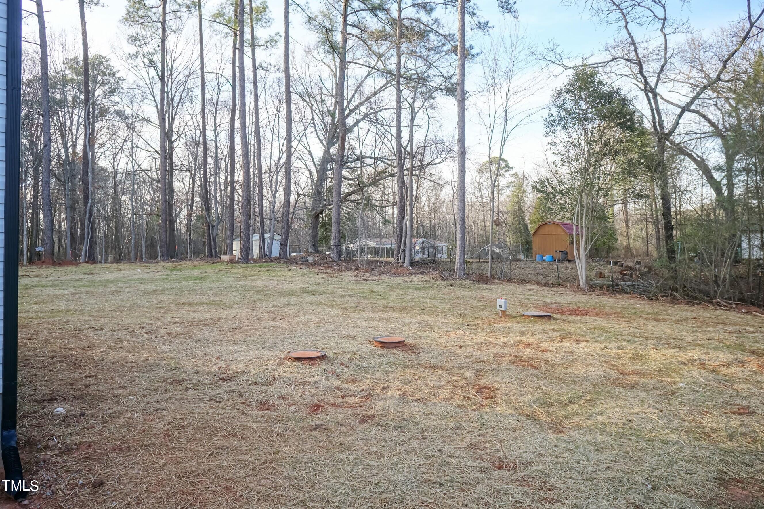 500 Poplar Springs Church Road Raleigh, NC 27603 - Photo 9 of 36 a backyard of a house with lots of green space
