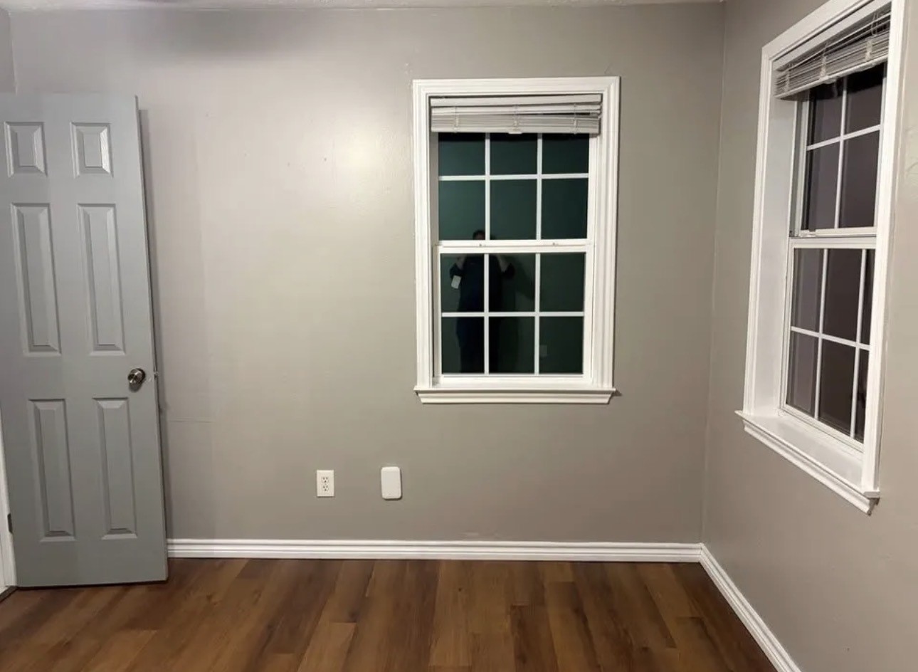 14529 Chapperal Pipeline Road, Unit A Conroe, TX 77302 - Photo 16 of 25 an empty room with wooden floor and windows