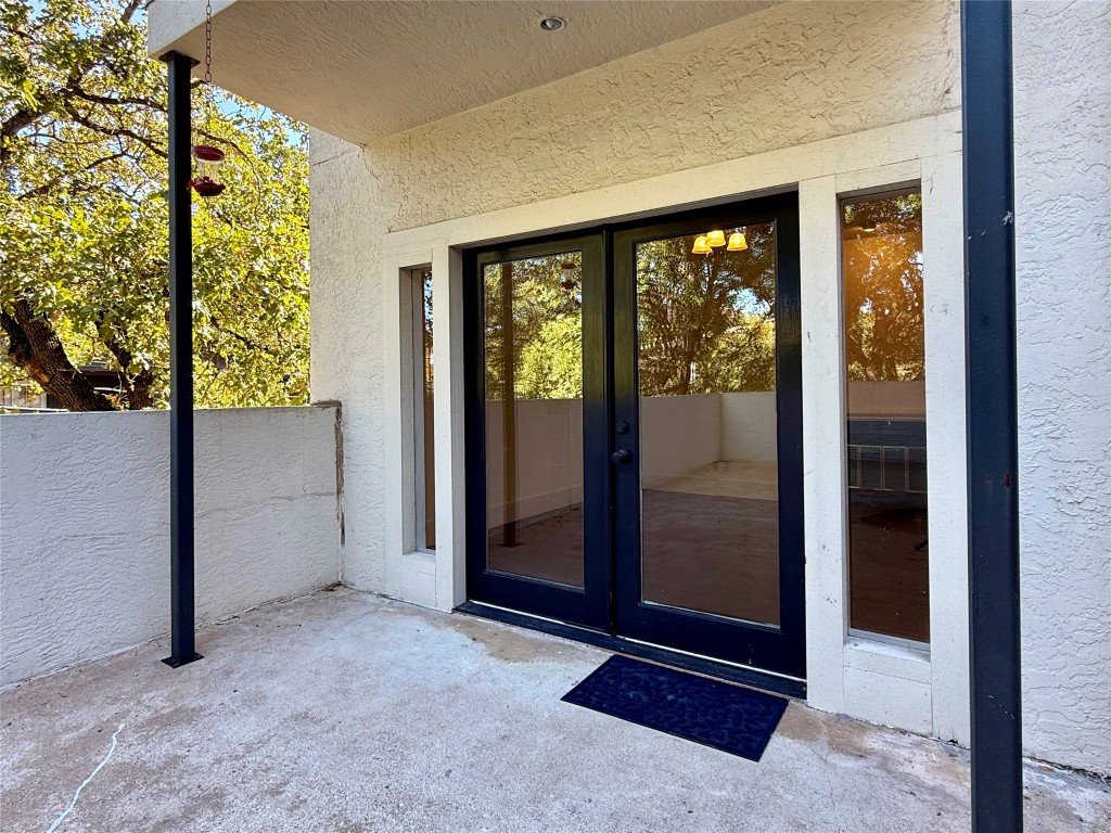 2605 Enfield Road, Unit 103 Austin, TX 78703 - Photo 15 of 17 View of exterior entry with french doors, a patio area, and stucco siding