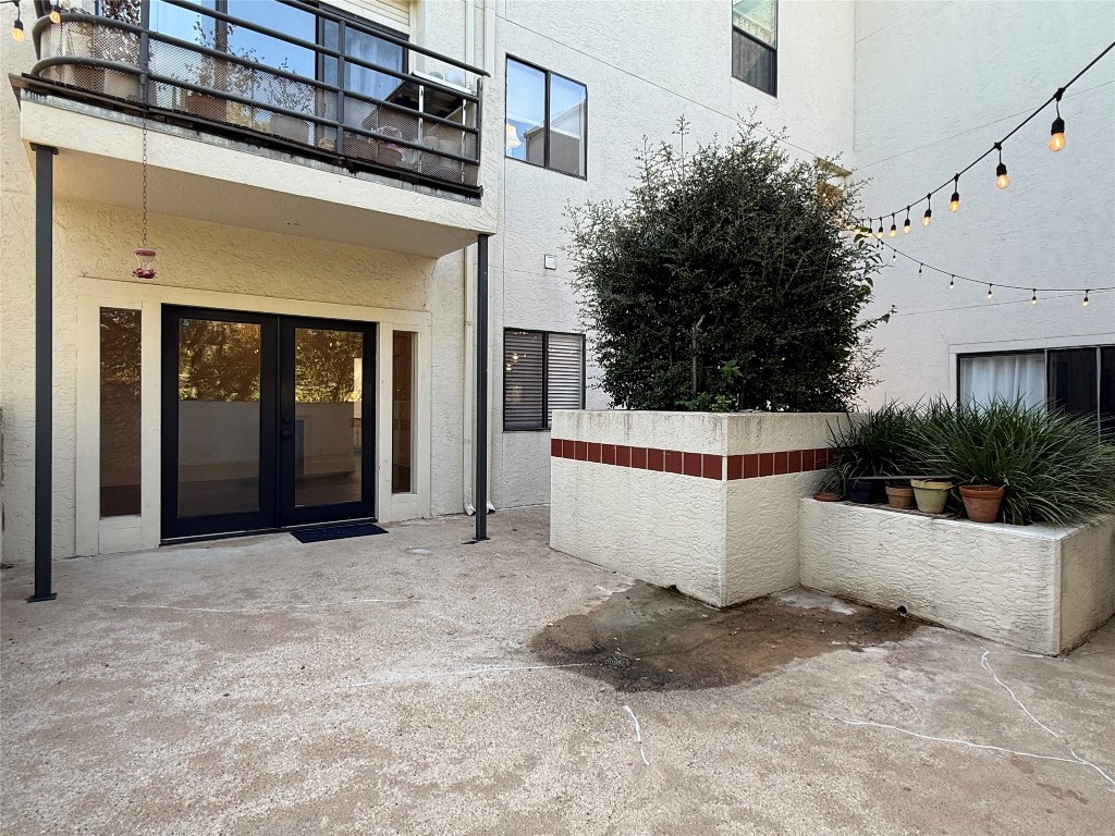 2605 Enfield Road, Unit 103 Austin, TX 78703 - Photo 16 of 17 View of exterior entry featuring a patio area, stucco siding, and french doors