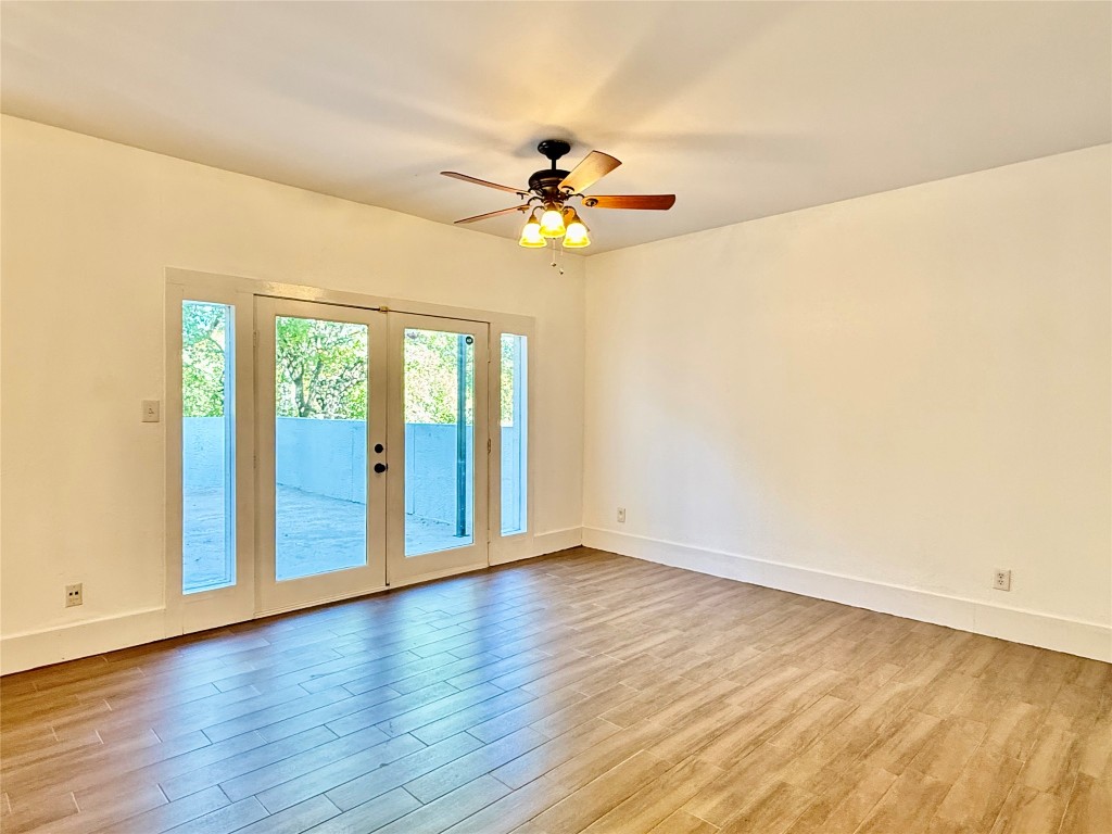 2605 Enfield Road, Unit 103 Austin, TX 78703 - Photo 8 of 17 Unfurnished room with french doors, light wood-style floors, and a ceiling fan