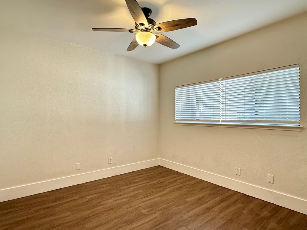 2605 Enfield Road, Unit 103 Austin, TX 78703 - Photo 10 of 17 Unfurnished room with dark wood-style flooring and a ceiling fan