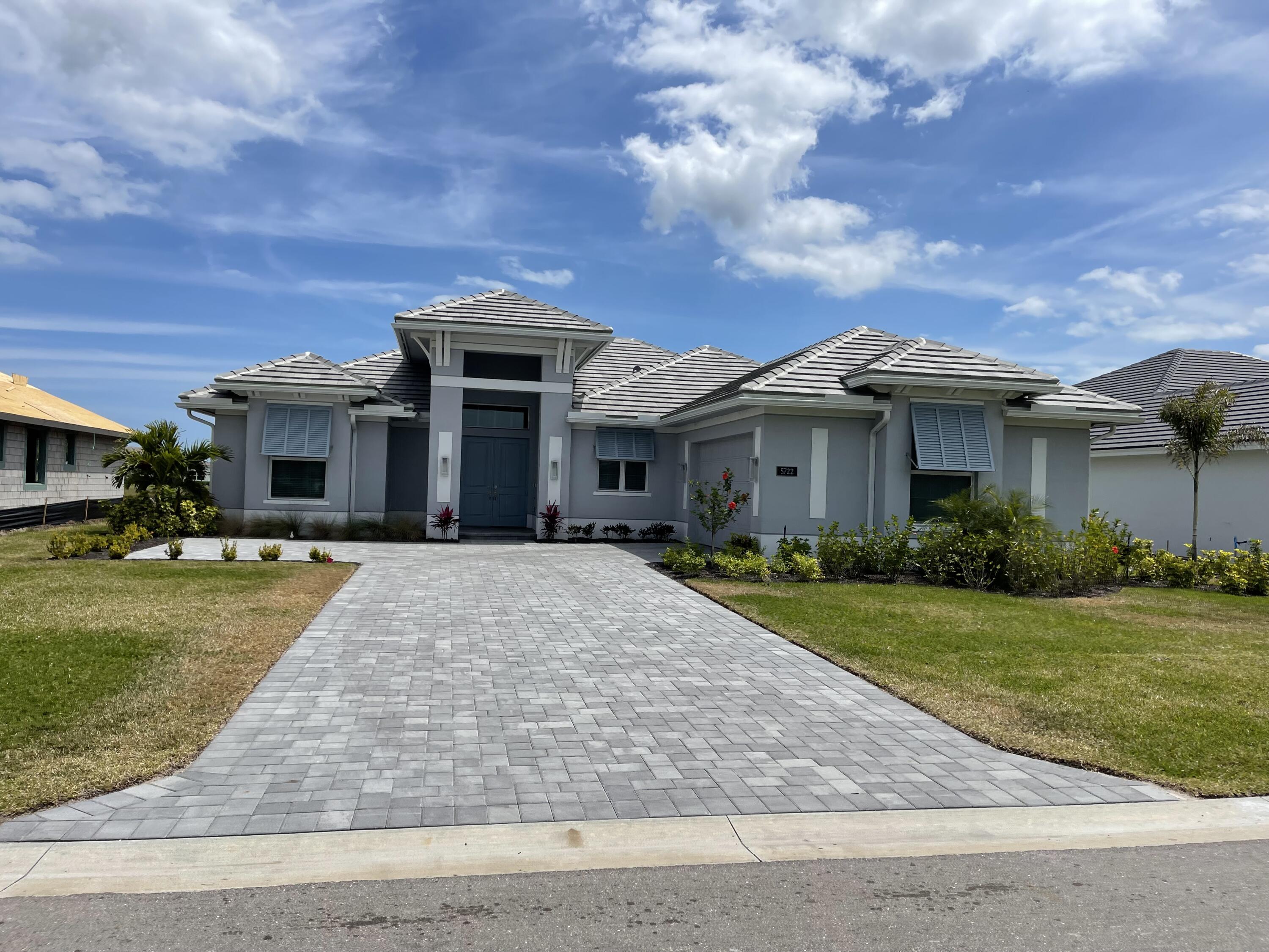 5722 Bent Pine Square Vero Beach, FL 32967 - Photo 1 of 1 a front view of a house with a yard