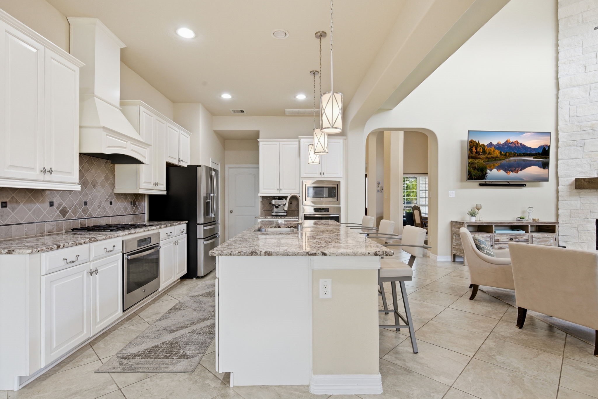 24534 Jenns Creek Court Spring, TX 77389 - Photo 12 of 31 a kitchen with stainless steel appliances kitchen island granite countertop a sink and cabinets