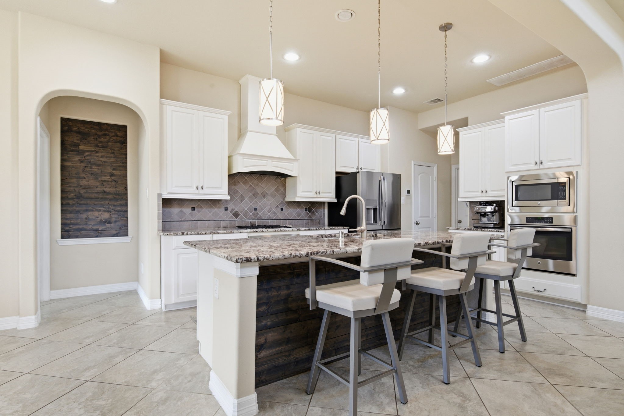 24534 Jenns Creek Court Spring, TX 77389 - Photo 13 of 31 a kitchen with stainless steel appliances kitchen island granite countertop a sink and a refrigerator