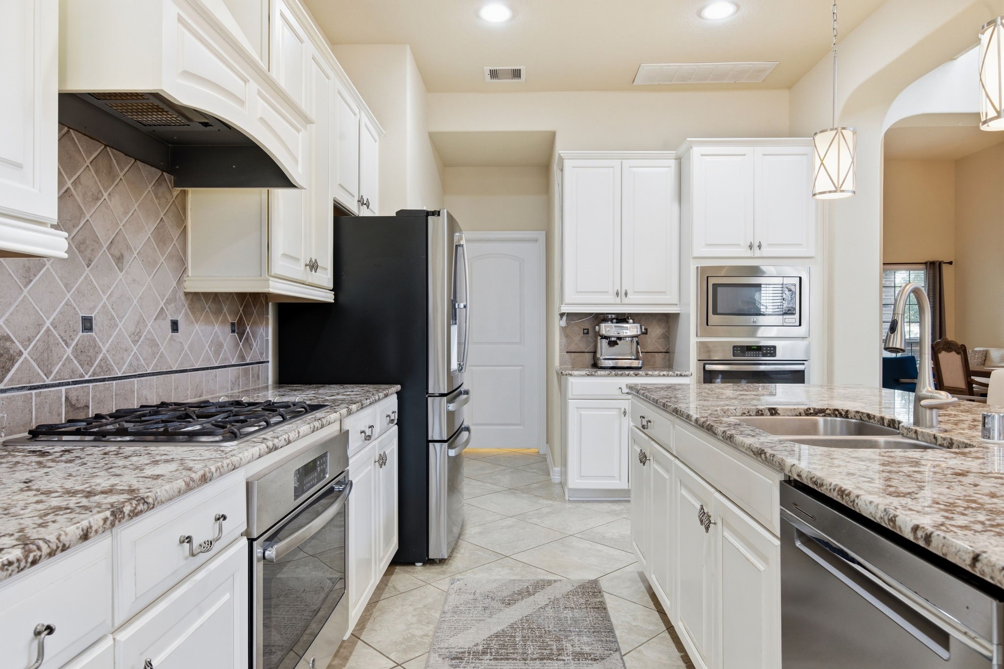 24534 Jenns Creek Court Spring, TX 77389 - Photo 15 of 31 a kitchen with stainless steel appliances granite countertop a sink stove and refrigerator