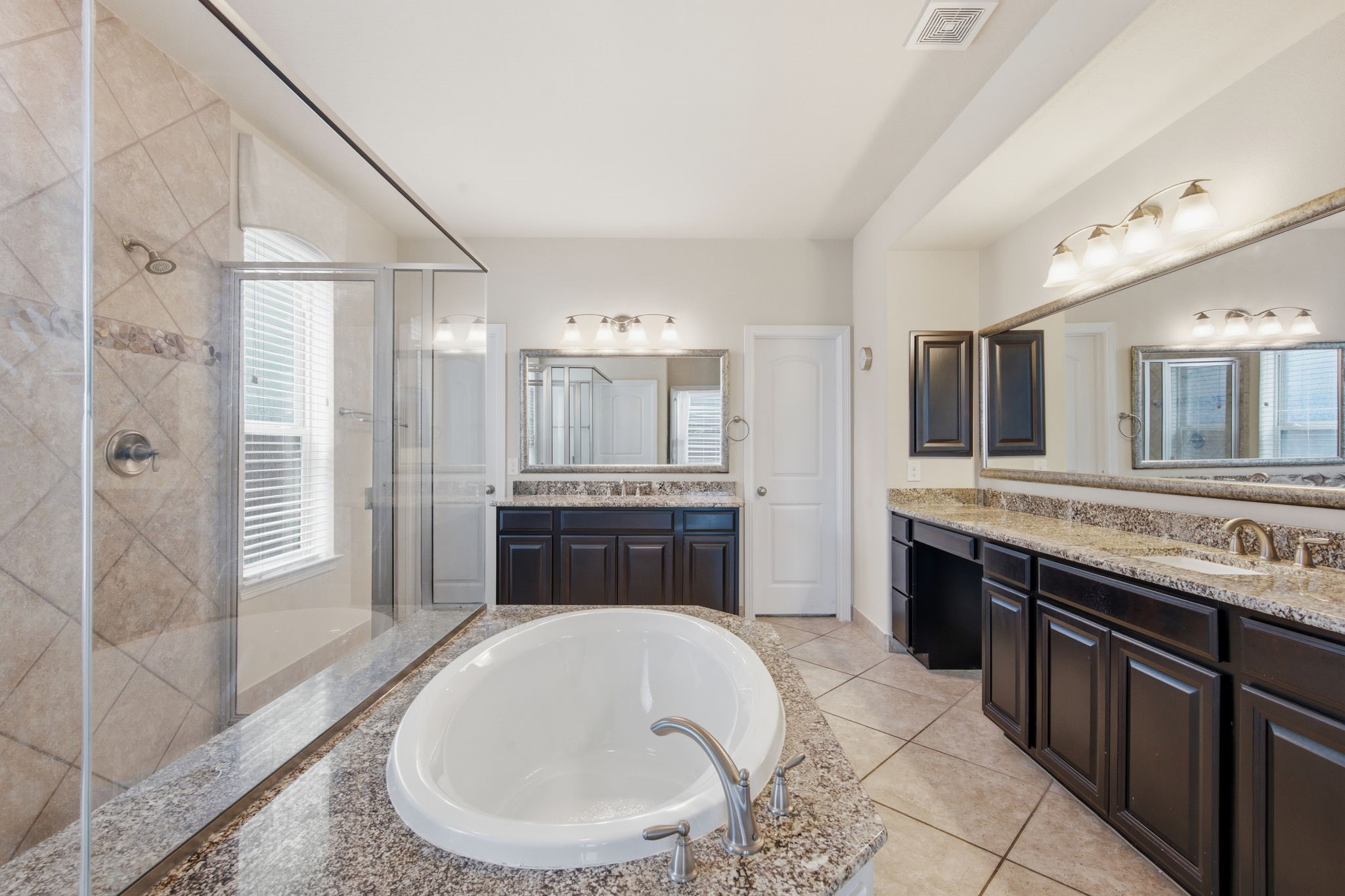24534 Jenns Creek Court Spring, TX 77389 - Photo 19 of 31 a spacious bathroom with a tub sink shower and mirror