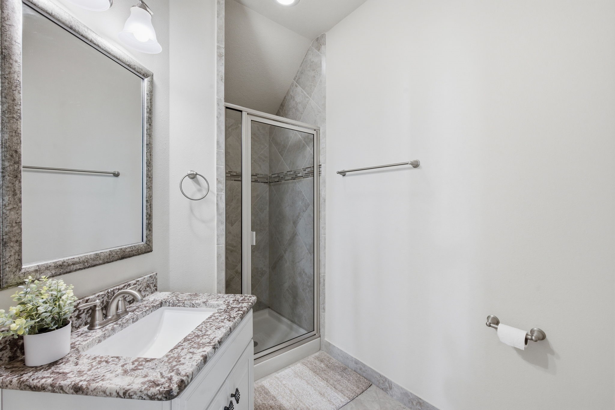 24534 Jenns Creek Court Spring, TX 77389 - Photo 7 of 31 a bathroom with a granite countertop sink and a mirror