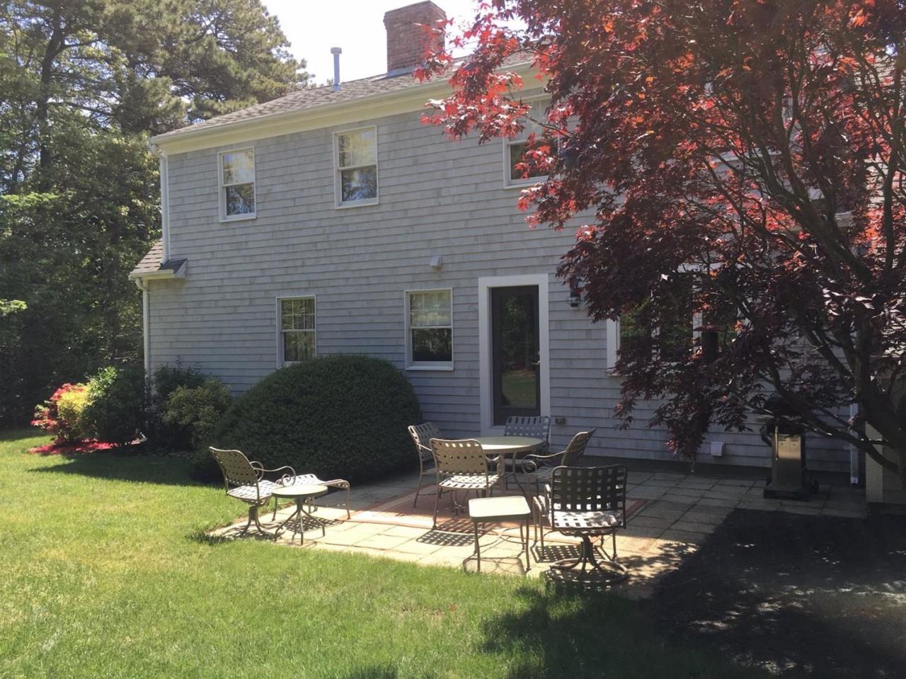 74 Oval Road Chatham, MA 02633 - Photo 14 of 16 a backyard of a house with lots of green space