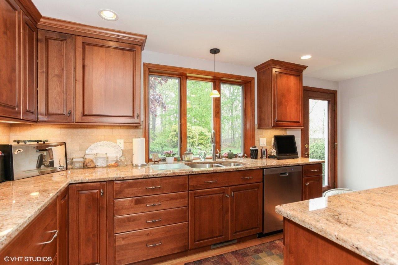 74 Oval Road Chatham, MA 02633 - Photo 7 of 16 a kitchen with granite countertop wooden cabinets a sink and dishwasher with wooden floor